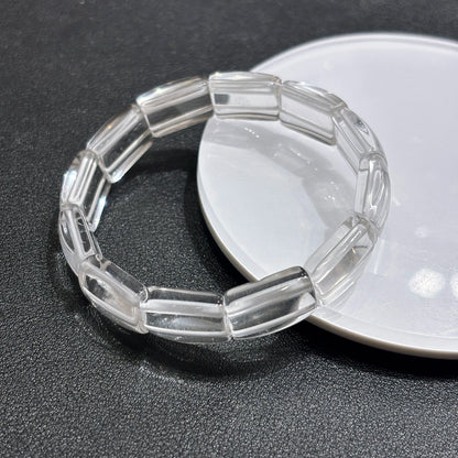 Two clear quartz square tablet bracelets layered on white ceramic dish, minimalist aesthetic stackable design