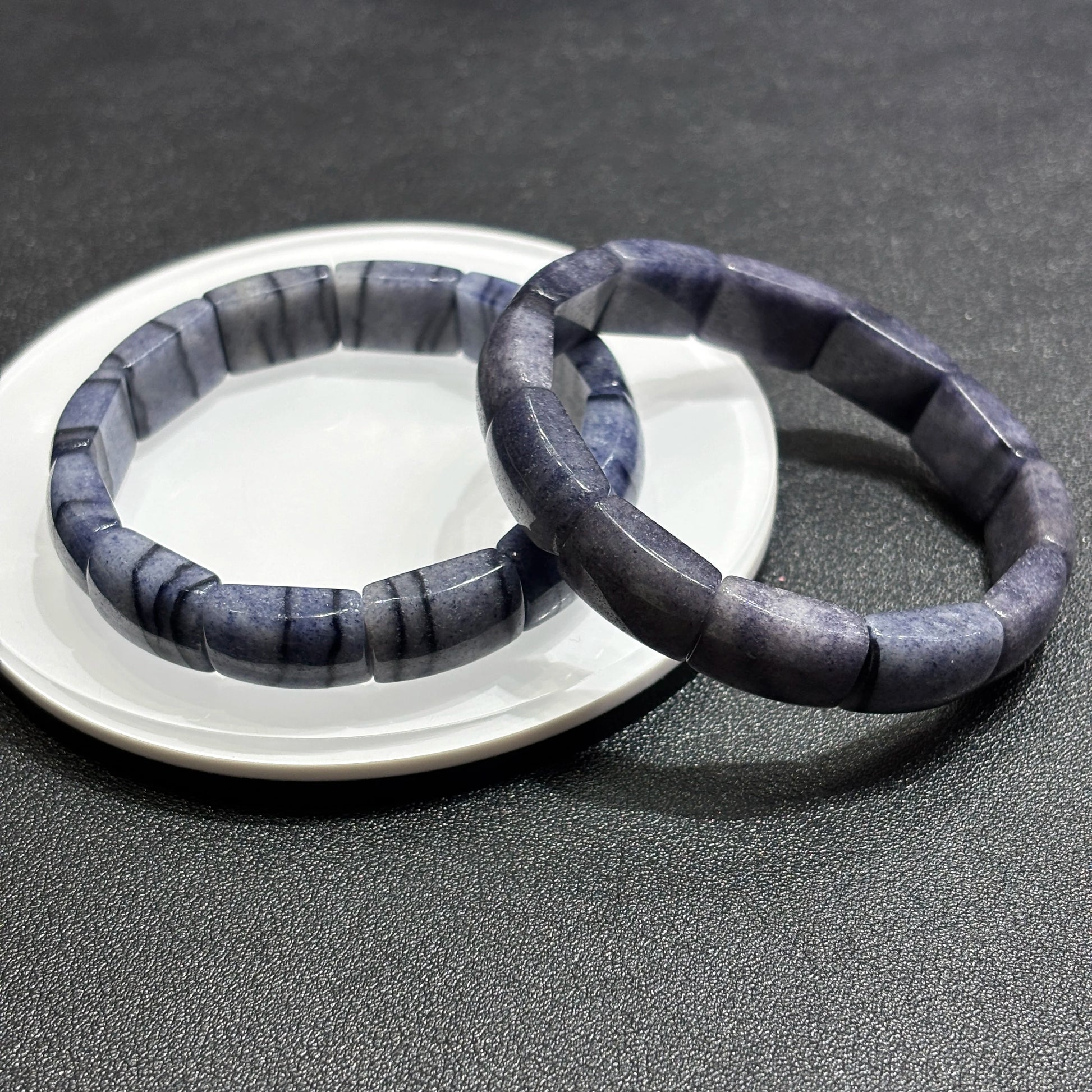 wo blue aventurine square tablet bracelets layered on white dish, highlighting natural mica inclusions and texture