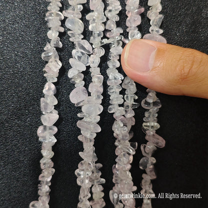 Detailed view of long 75cm natural star rose quartz chipped strand ready for DIY projects