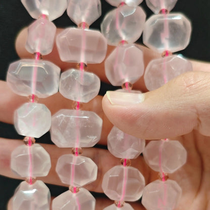 Close up perspective of multiple natural translucent rose quartz faceted freeform bead strands showing smooth polished finish