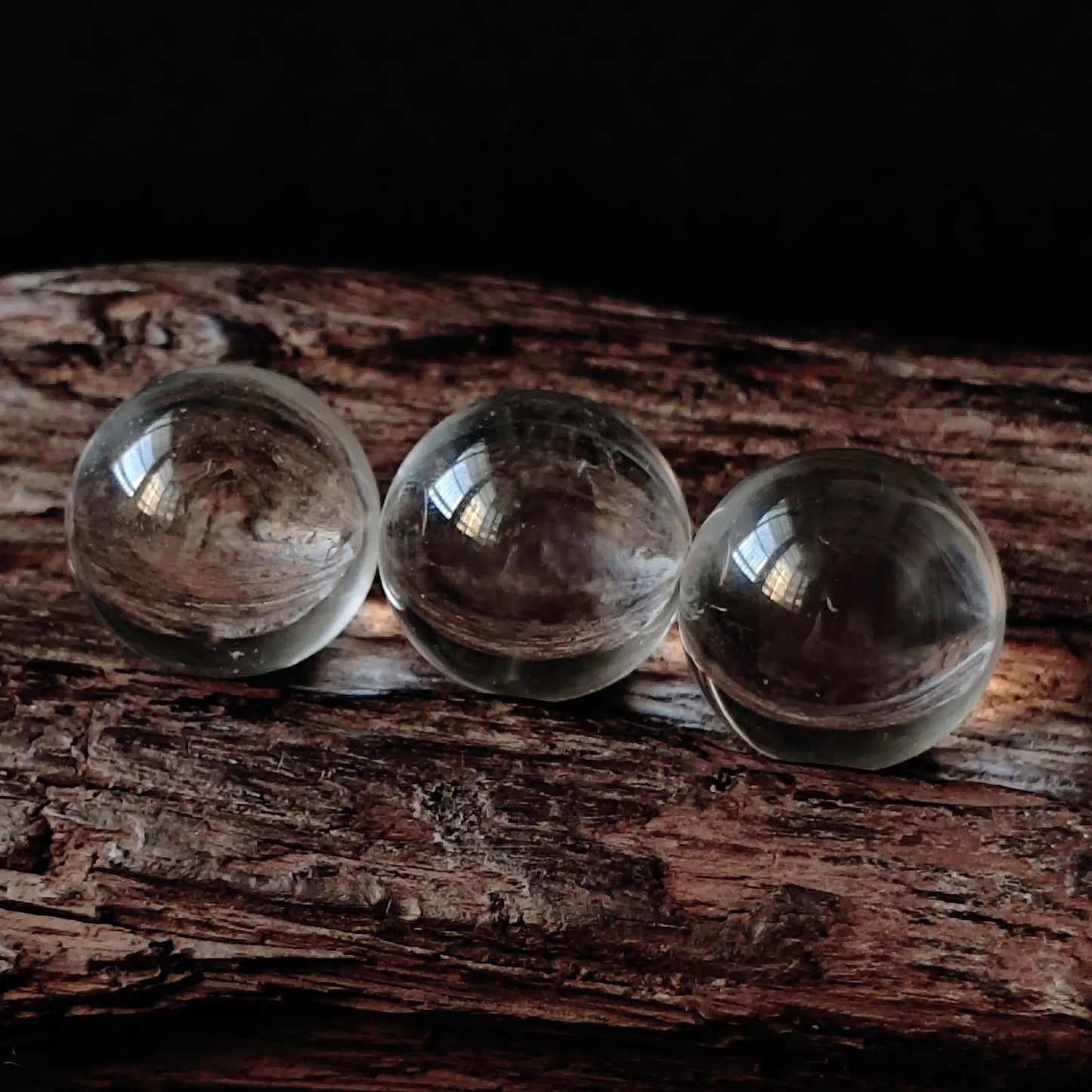 Three clear quartz spheres aligned on resin base—ideal for intention setting, meditation focus, or elegant desktop styling