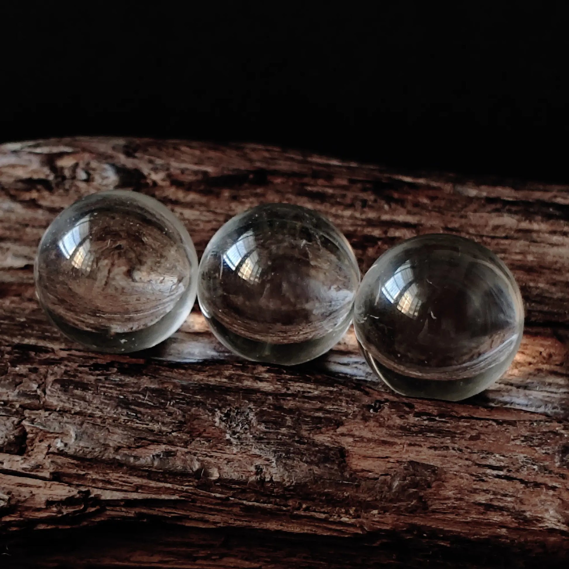 Three clear quartz spheres aligned on resin base—ideal for intention setting, meditation focus, or elegant desktop styling