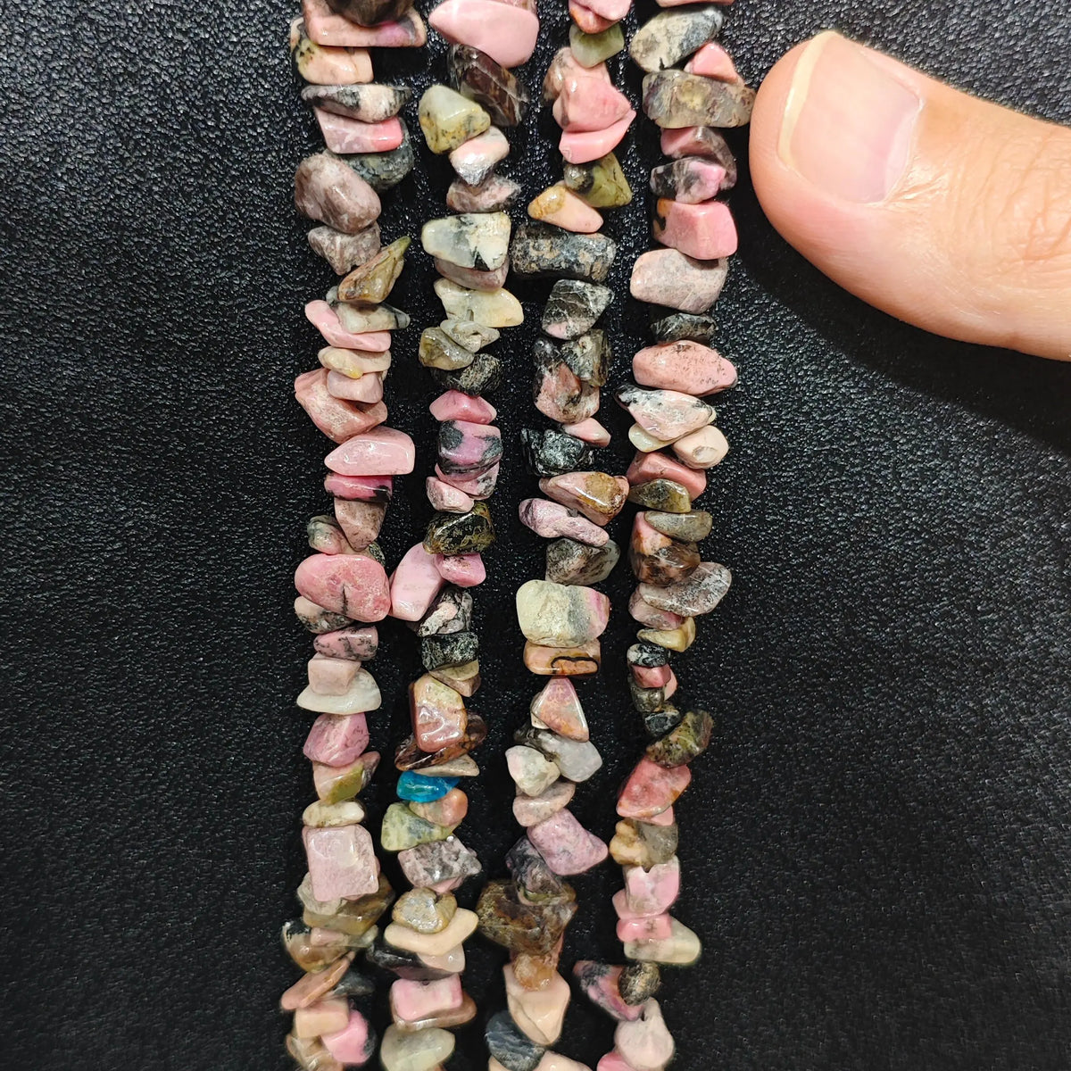 Multiple strands of natural rhodonite 5-10mm irregular pink and black chip beads for jewelry crafting[cite: 11]