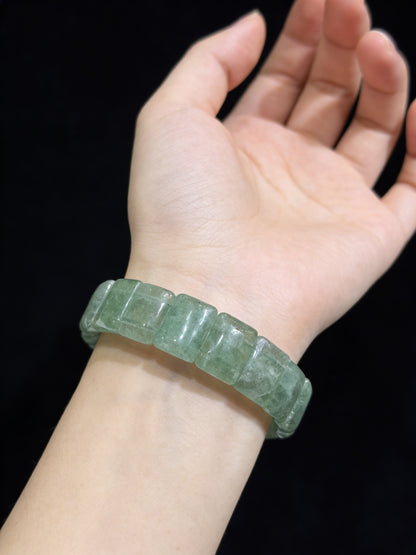 Hand wearing natural green strawberry quartz square bead bracelet; subtle translucency enhances calm presence, ideal for daily wear