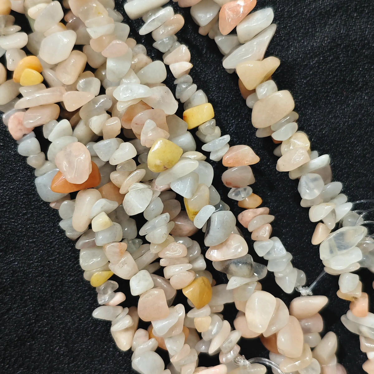 Multiple strands of natural pink aventurine 5-10mm irregular chip beads showing soft pastel tones