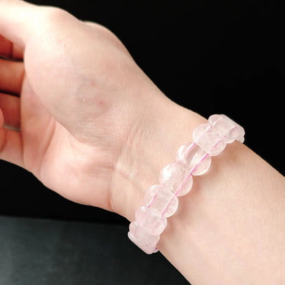 Flexible rose quartz handchain moving naturally on wrist, showcasing its lightweight design and harmonious aesthetic for mindful living