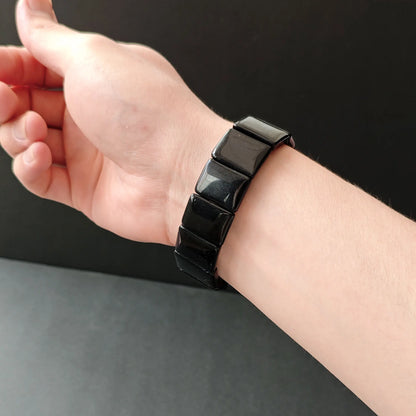 Black obsidian square bead handchain worn on wrist, showcasing elegant fit for daily casual wear