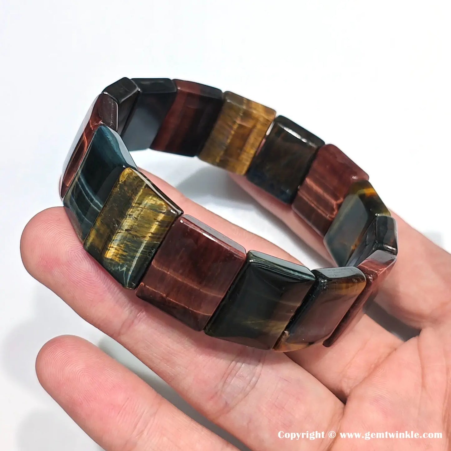 Tiger eye elastic bangle worn on wrist, demonstrating comfortable stretch fit and vibrant banding pattern — ideal for small business inventory and customer try-on
