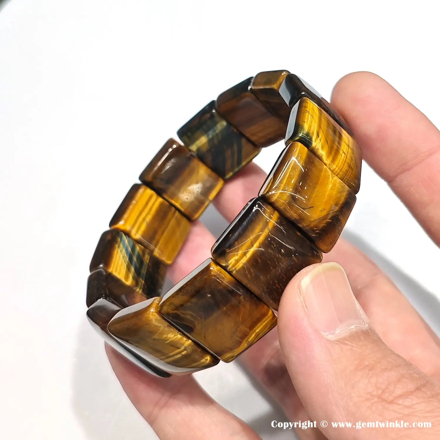 Yellow tiger eye elastic bracelet worn on wrist, demonstrating comfortable stretch fit for 18cm circumference — unisex style for small business inventory