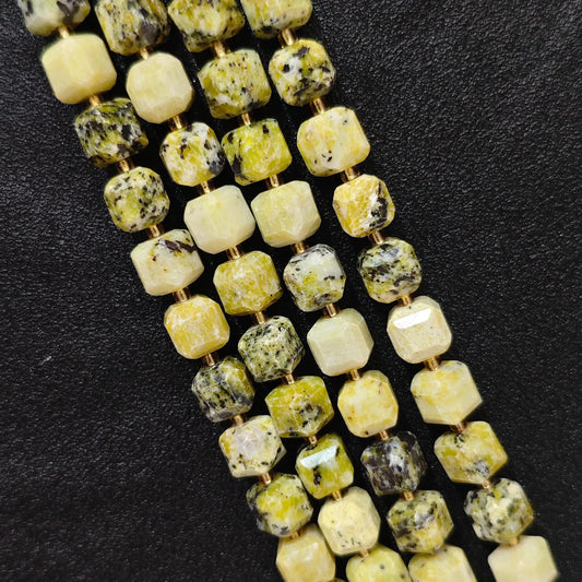 Close up of multi strands of natural yellow jasper soft-tumbled geometric cube beads showing overall strand layout