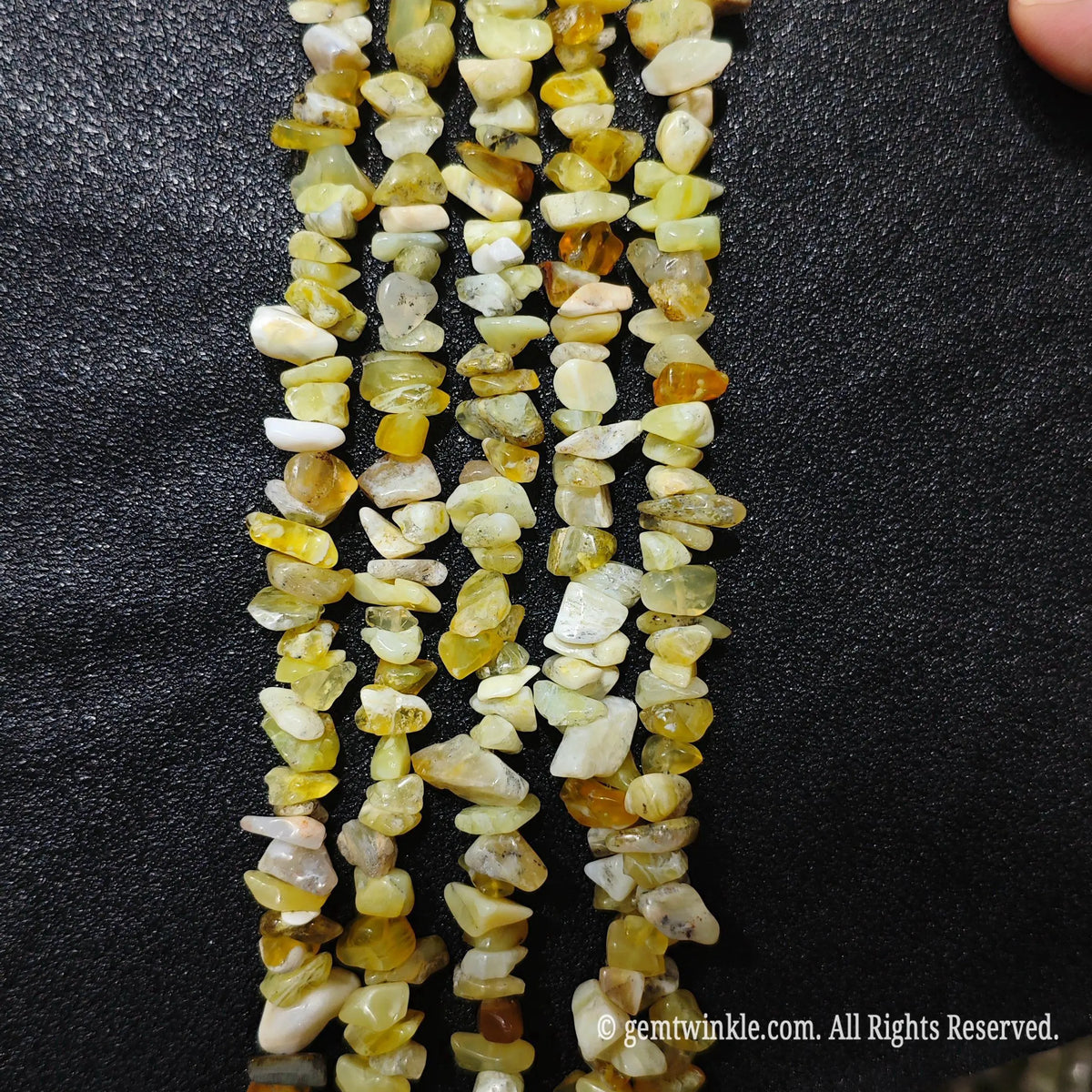 Detailed view of long 75cm natural yellow opal chipped strand ready for wholesale DIY projects