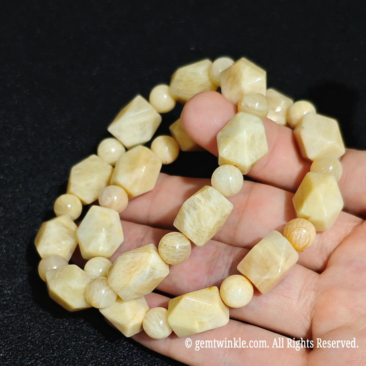 Side view of two natural golden yellow quartzite faceted freeform stretch bracelets showing honey tones