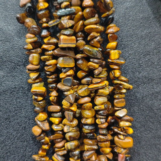 Close up of multi strands of natural yellow tiger eye 5-10mm irregular golden brown chatoyant chips[cite: 8]
