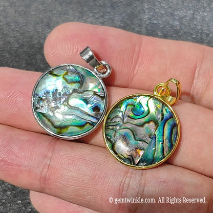 Pair of 2cm round abalone shell pendants comparing gold tone and silver tone alloy bezel settings side by side