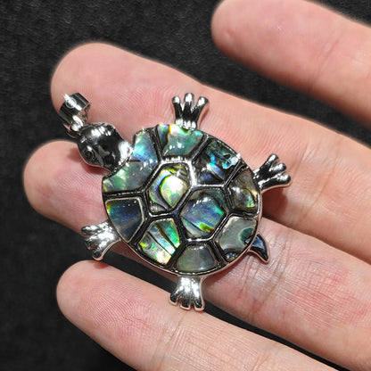 Side view of 35mm abalone shell tortoise pendant showing detailed alloy metal limbs and top bail attachment