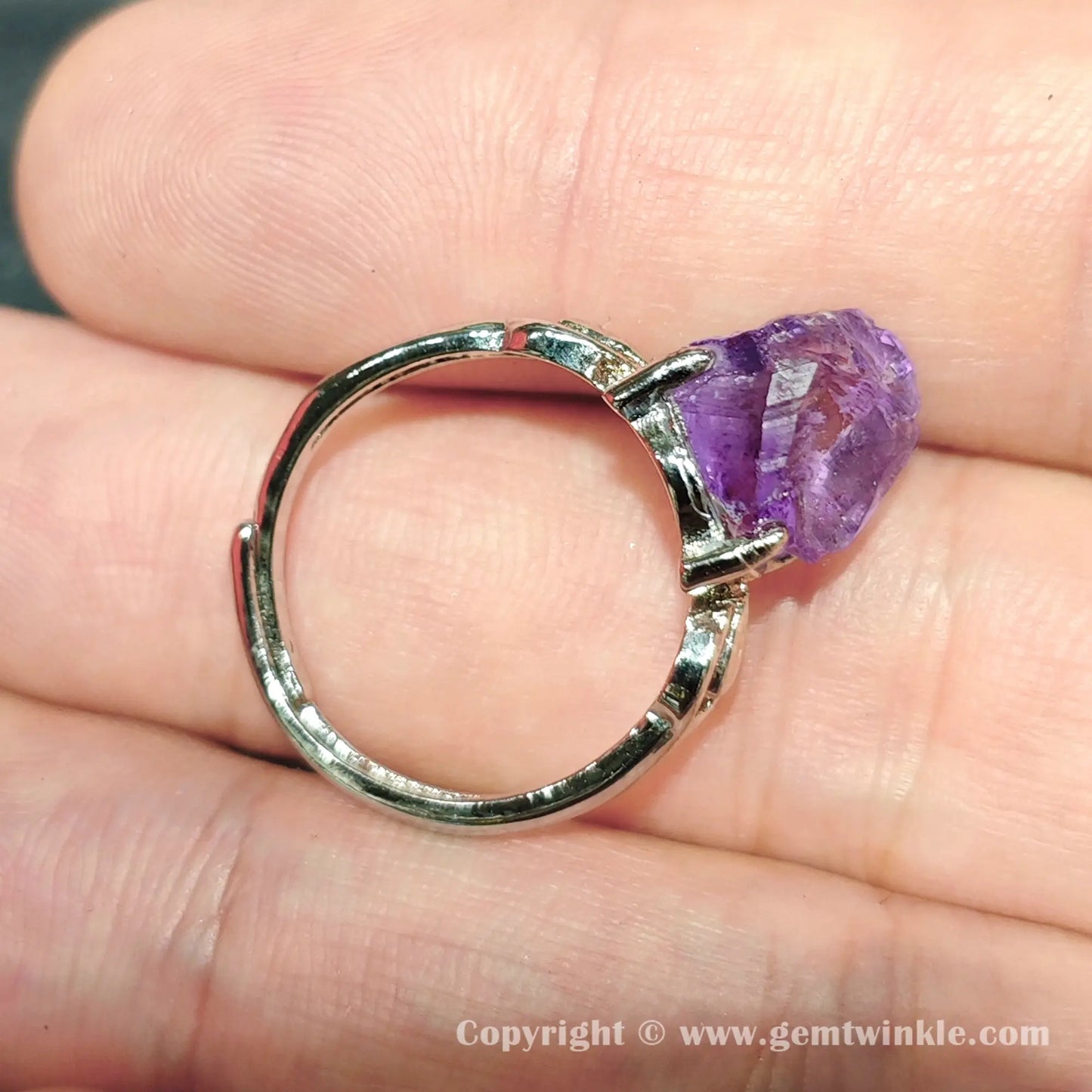 Side view of open back adjustable silver-tone metal alloy ring band showing raw amethyst stone