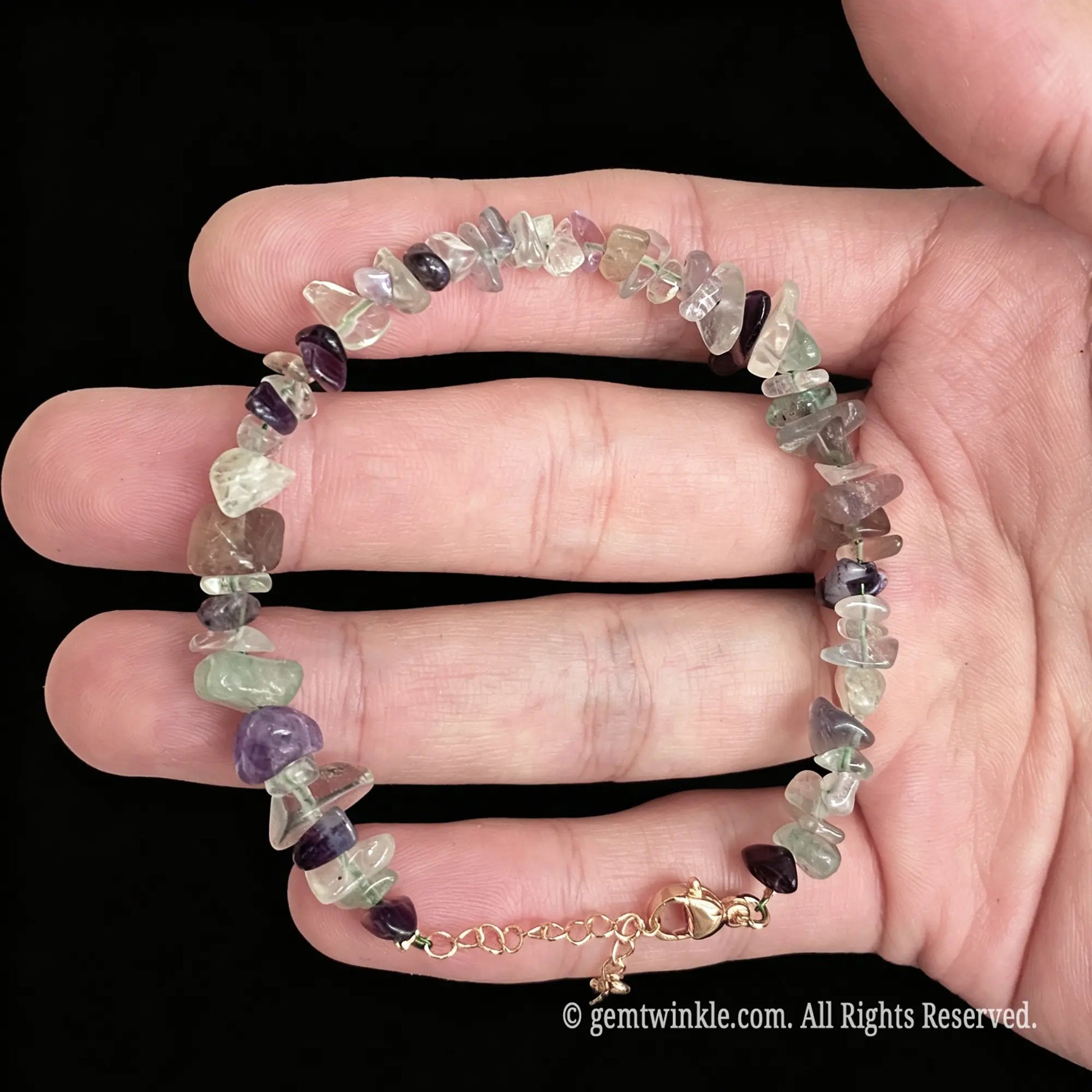 adjustable rainbow fluorite chip bracelet showing gold tone lobster clasp and extension chain detail