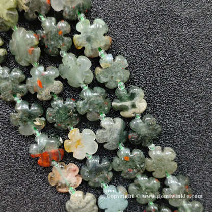 Natural African bloodstone plum blossom carved bead strand held over hand showing size scale