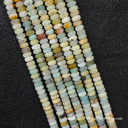 Perspective view of amazonite faceted heishi spacer beads showing uniform 3mm disc thickness