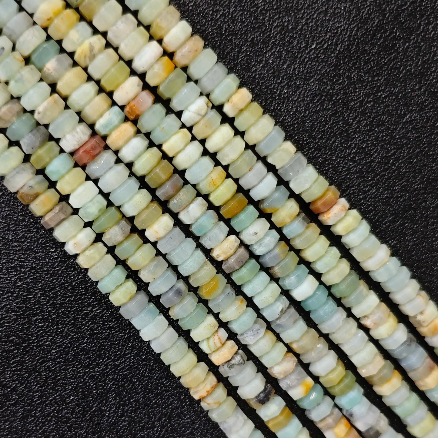 Macro closeup of natural amazonite faceted rondelle beads 6x3mm showing mint green seafoam matrix