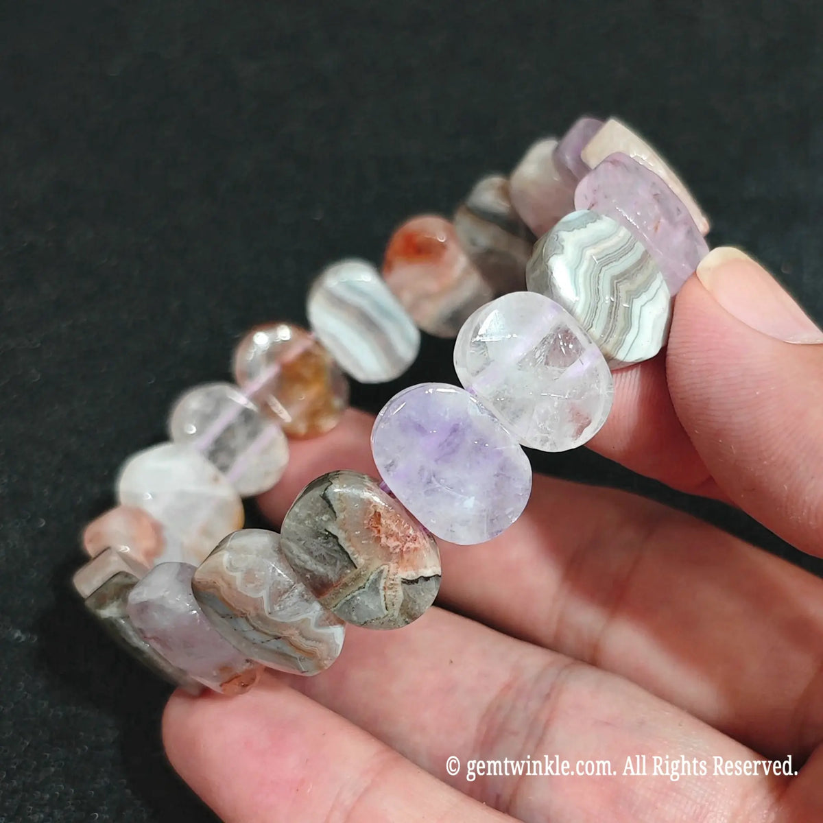 Macro close-up showing the concentric quartz layers and purple amethyst patches in agate blocks