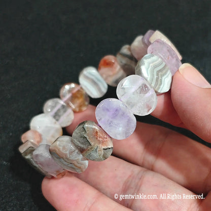 Macro close-up showing the concentric quartz layers and purple amethyst patches in agate blocks