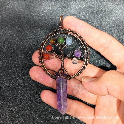 Handheld view of 8cm tree of life amethyst point pendant showing natural ice inclusions