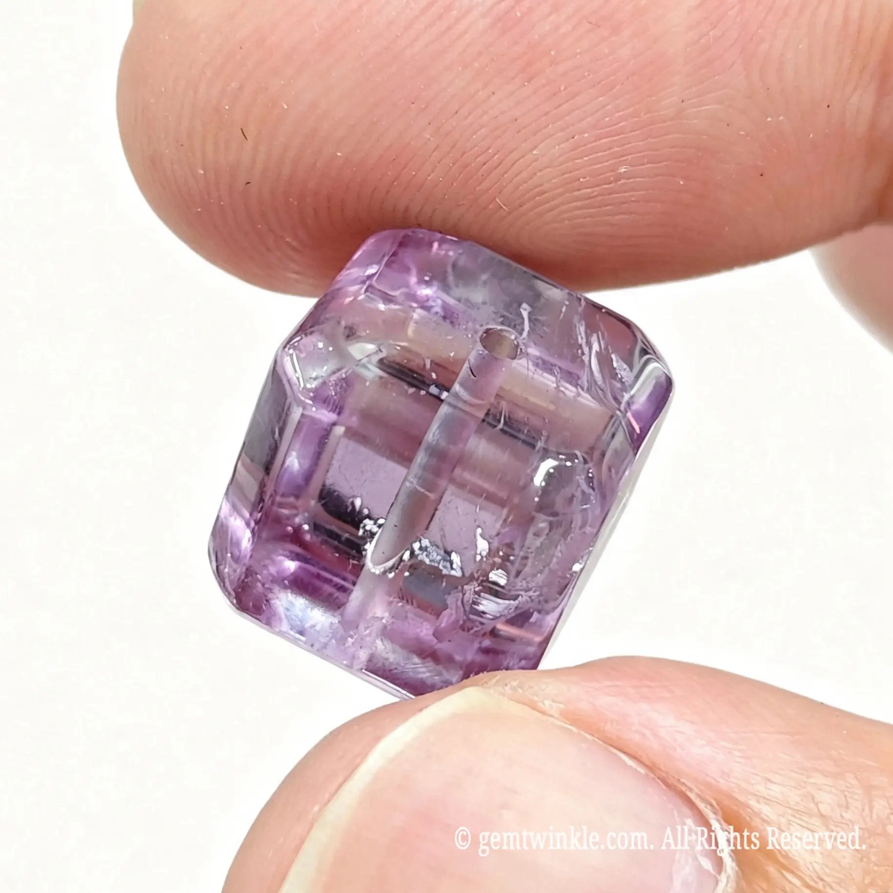 Angled view of amethyst cube bead showing geometric shape and rich violet color clarity