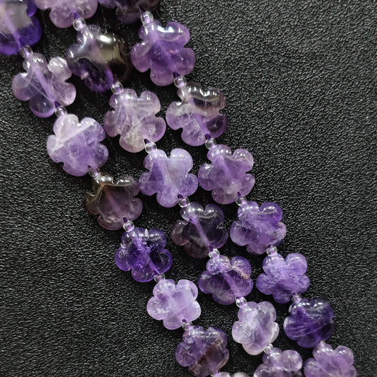 Macro closeup of amethyst quartz plum blossom carved beads 15mm showing purple crystal clarity