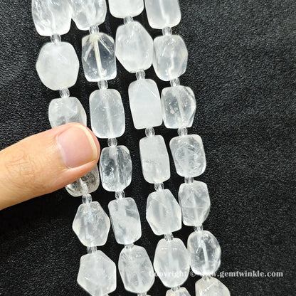angle view of included clear quartz faceted barrel beads catching light