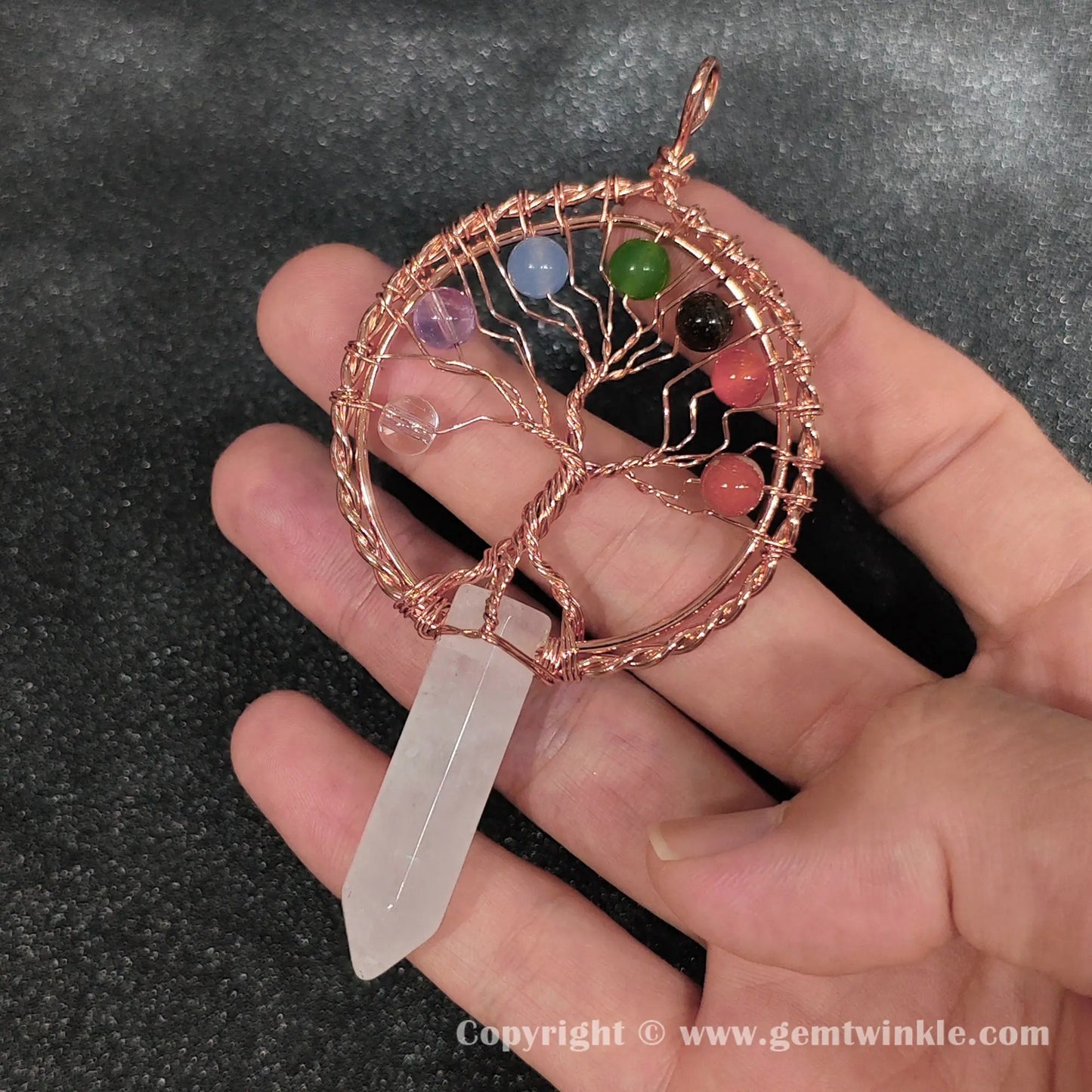 Angled hand preview of 8cm wire wrapped white quartz hexagon point pendant for jewelry making