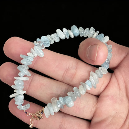 detail view of gold tone alloy clasp and extender chain on aquamarine bracelet