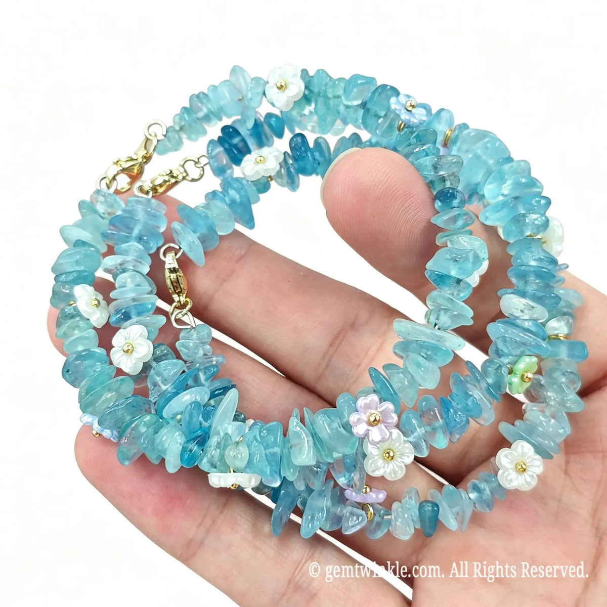 Coiled layout of aquamarine chip bracelet on wire showing 5-10mm gemstone gravel beads