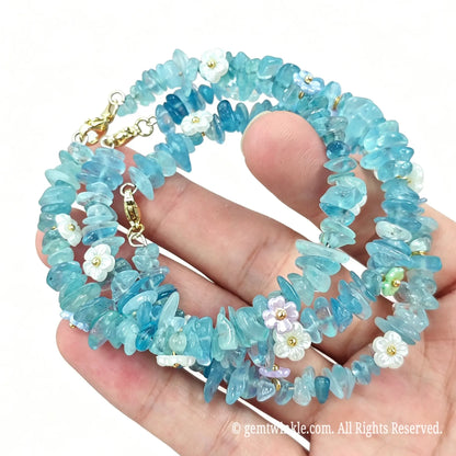 Coiled layout of aquamarine chip bracelet on wire showing 5-10mm gemstone gravel beads