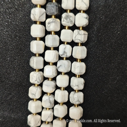 Designer hand holding white turquoise gemstone strands to demonstrate bead scale and polished luster