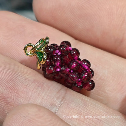 Front view of authentic garnet grape pendant bead showing size proportions and secure top hanging loop on finger