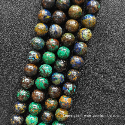 Parallel view of natural azurite malachite round bead strands placed on dark textured background