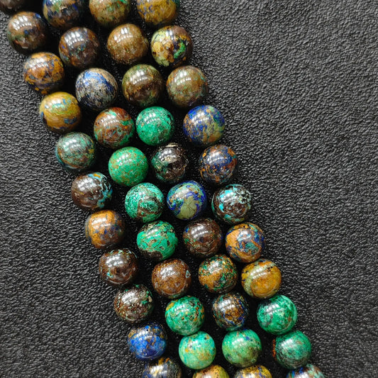 Macro closeup showing natural azurite malachite smooth round beads with vibrant blue and green veins