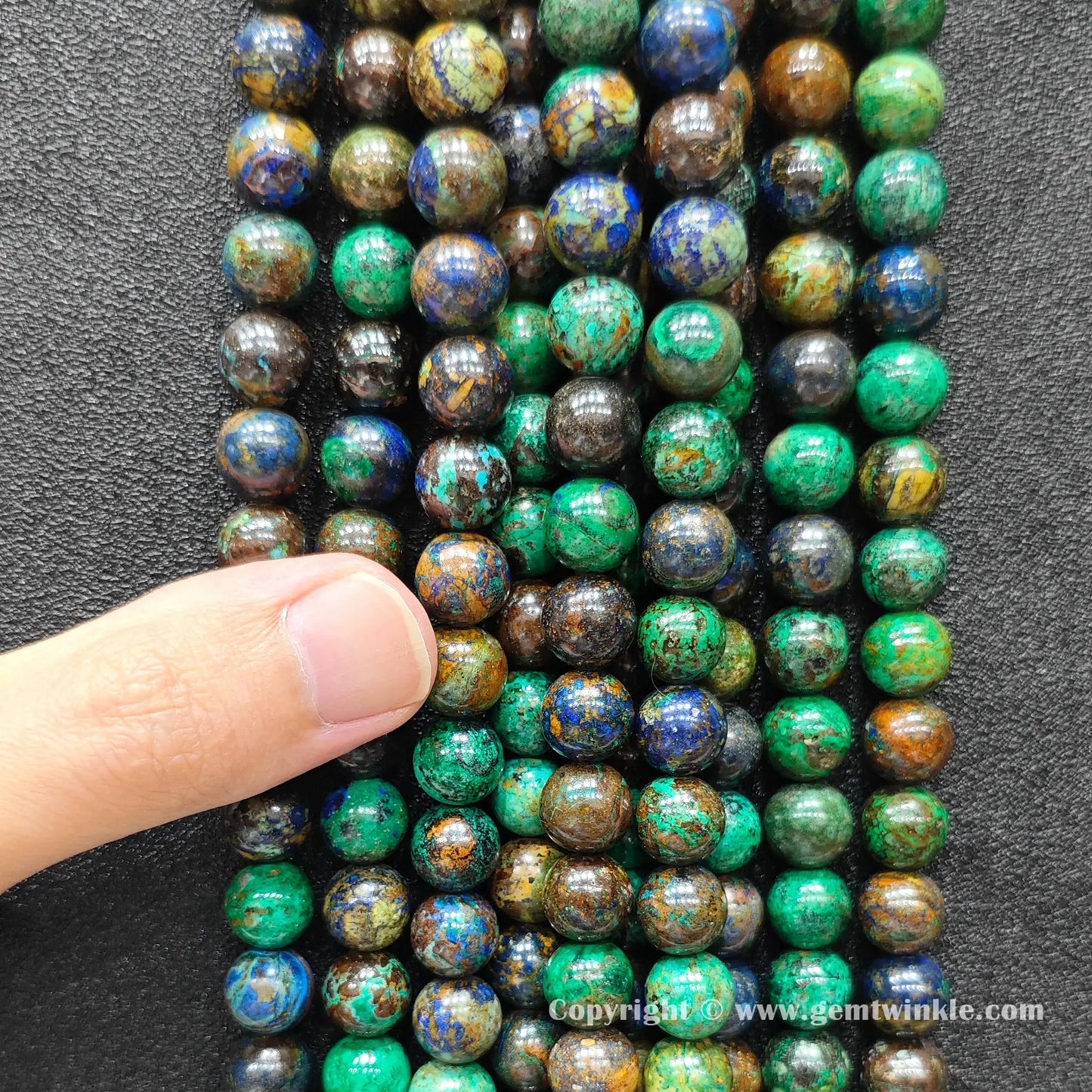 Perspective view of azurite malachite round beads highlighting polished finish across 4mm to 12mm sizes