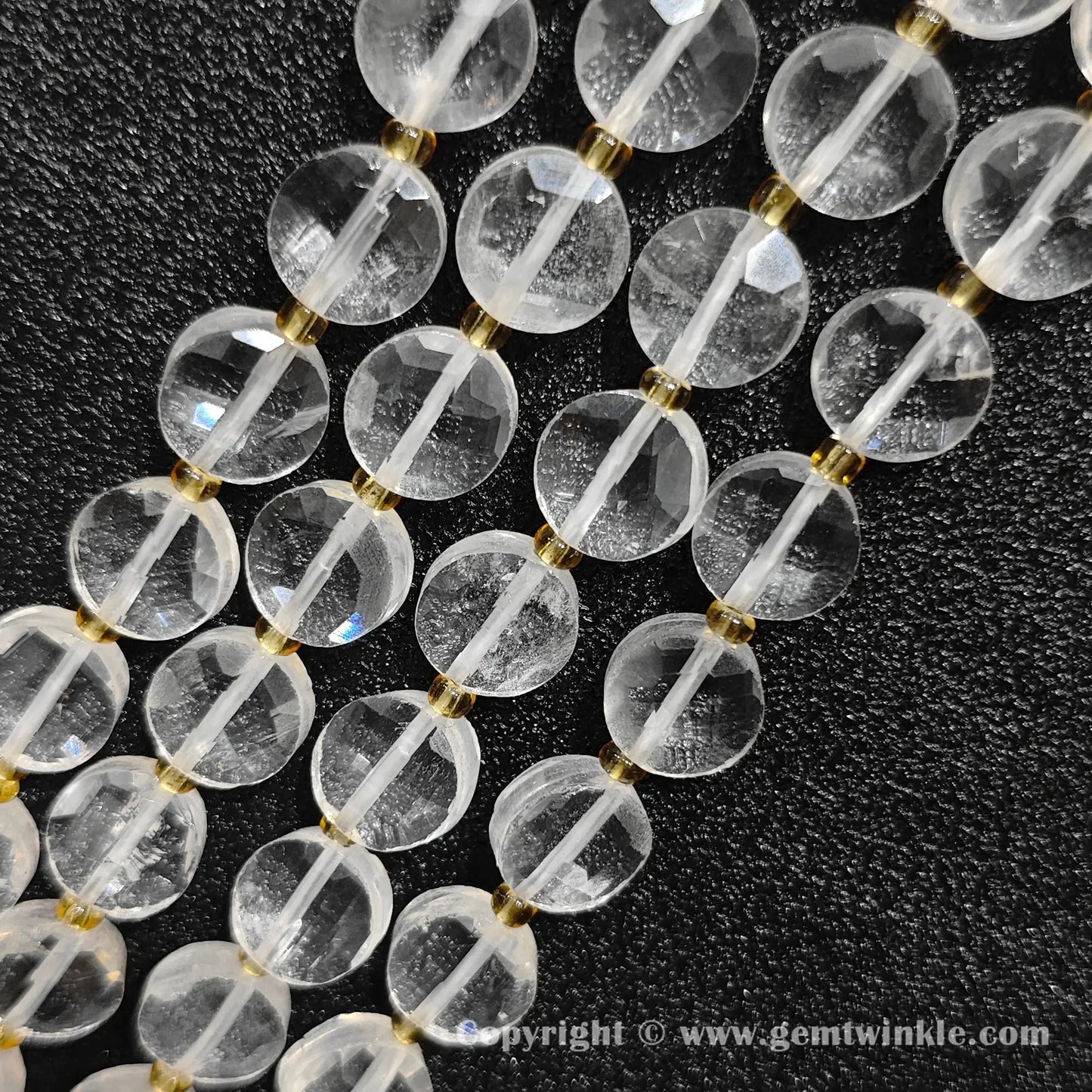 Close up view of B-grade clear rock quartz faceted disc beads showing natural veil inclusions