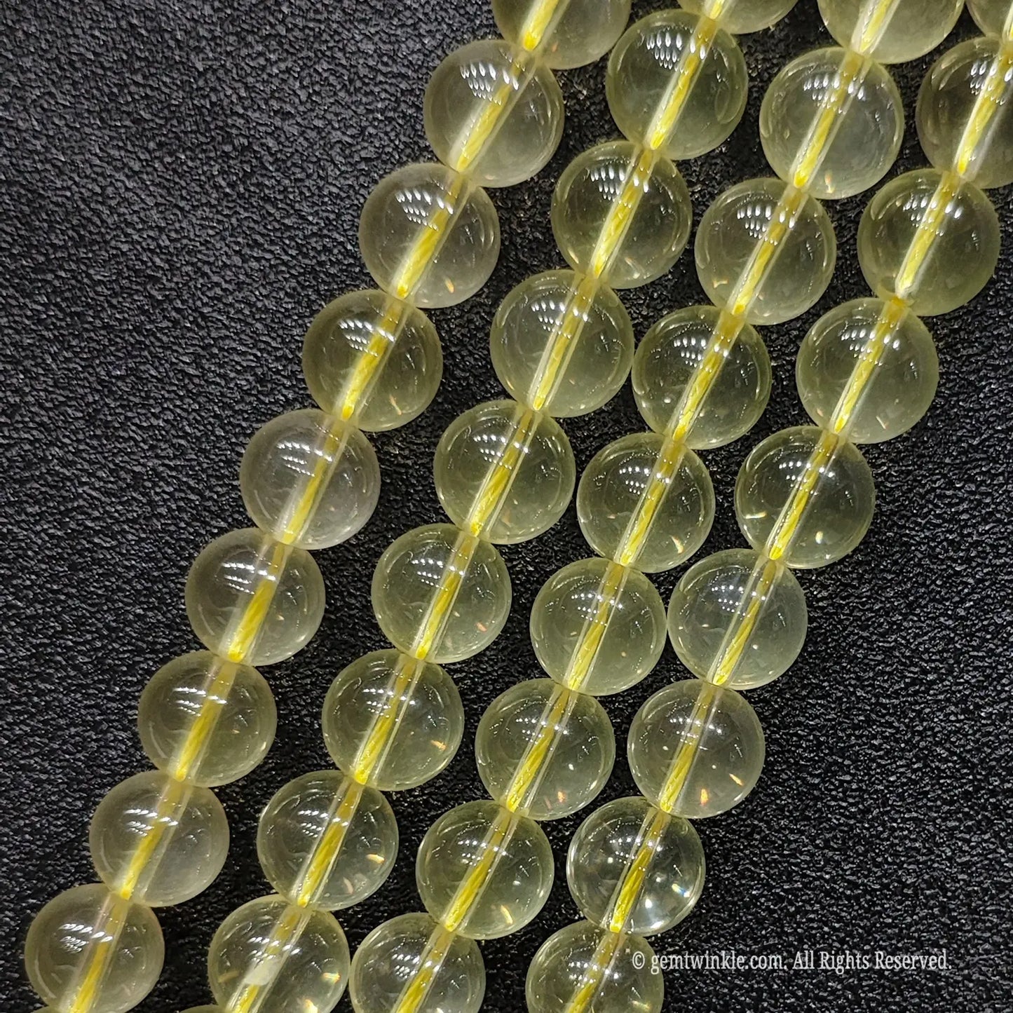 B plus grade milky lemon citrine crystal round strands in 8mm and 10mm showing subtle inner translucency