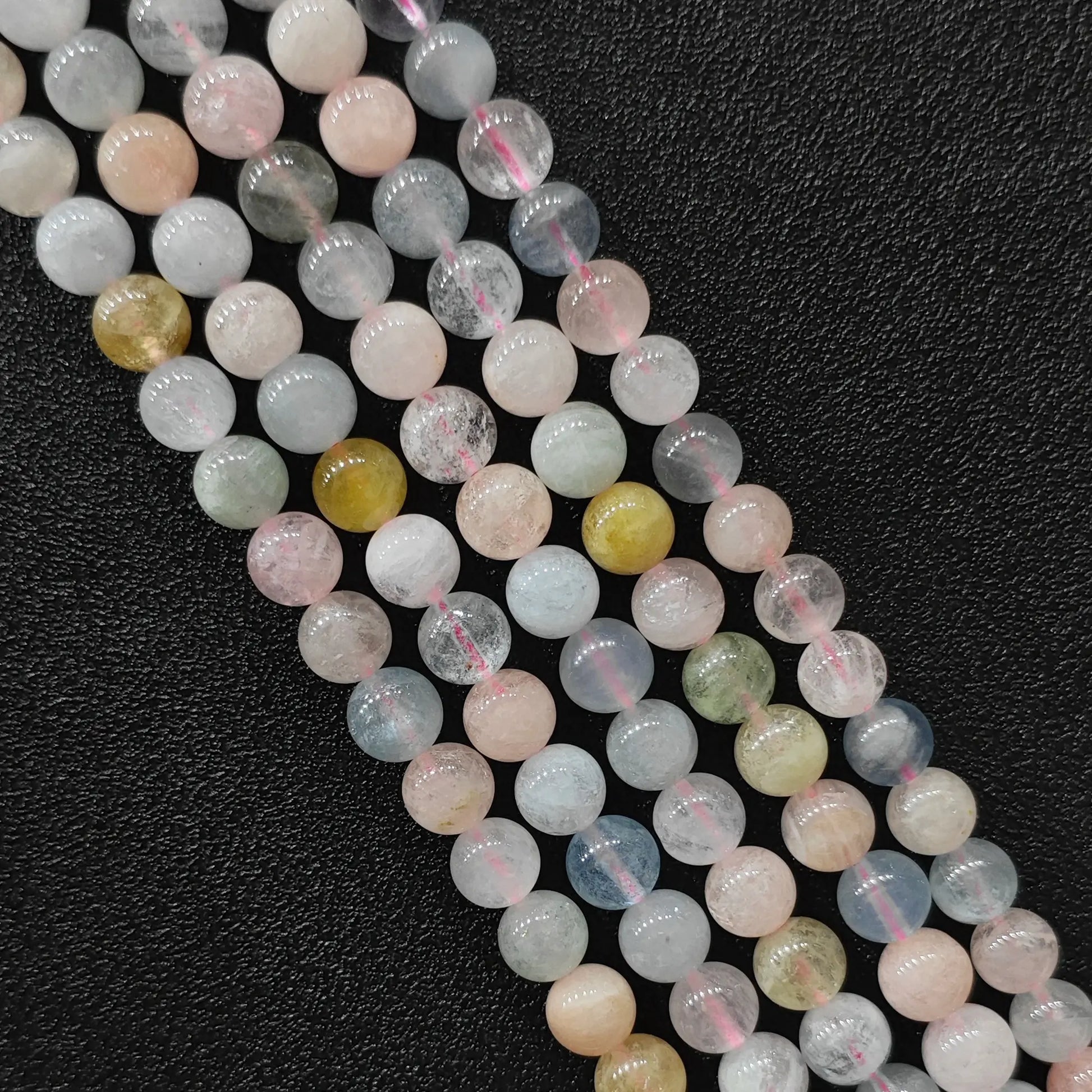 Close up view of b plus grade translucent multi color morganite crystal beads strands showing pastel pink and blue beryl minerals in image_cacfa4.jpg