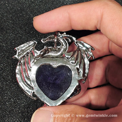 Back view of metallic alloy dragon frame enclosing natural purple heart amethyst cabochon