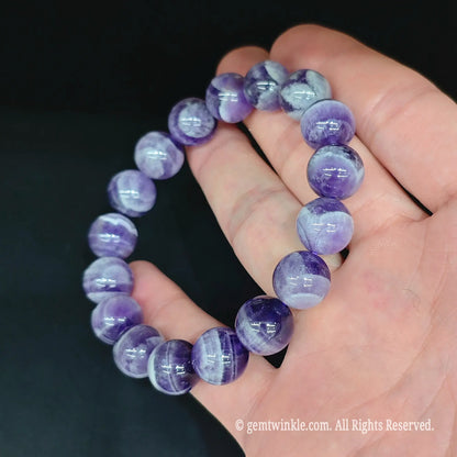 Banded purple dream amethyst bead stretch bracelet top view showing uniform round bead arrangement and smooth finish