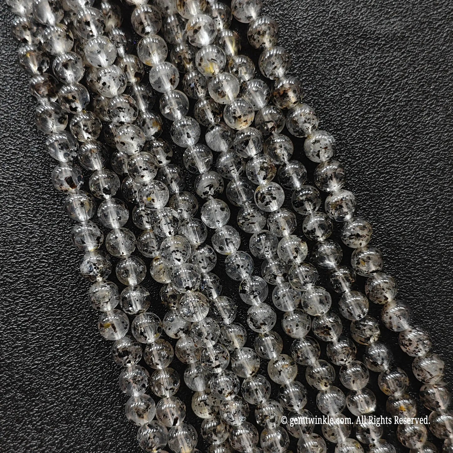 Biotite quartz crystal beads strands showcasing clear quartz structures loaded with organic dark mica minerals
