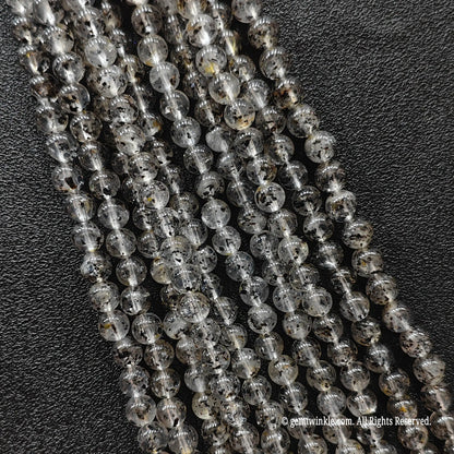 Biotite quartz crystal beads strands showcasing clear quartz structures loaded with organic dark mica minerals