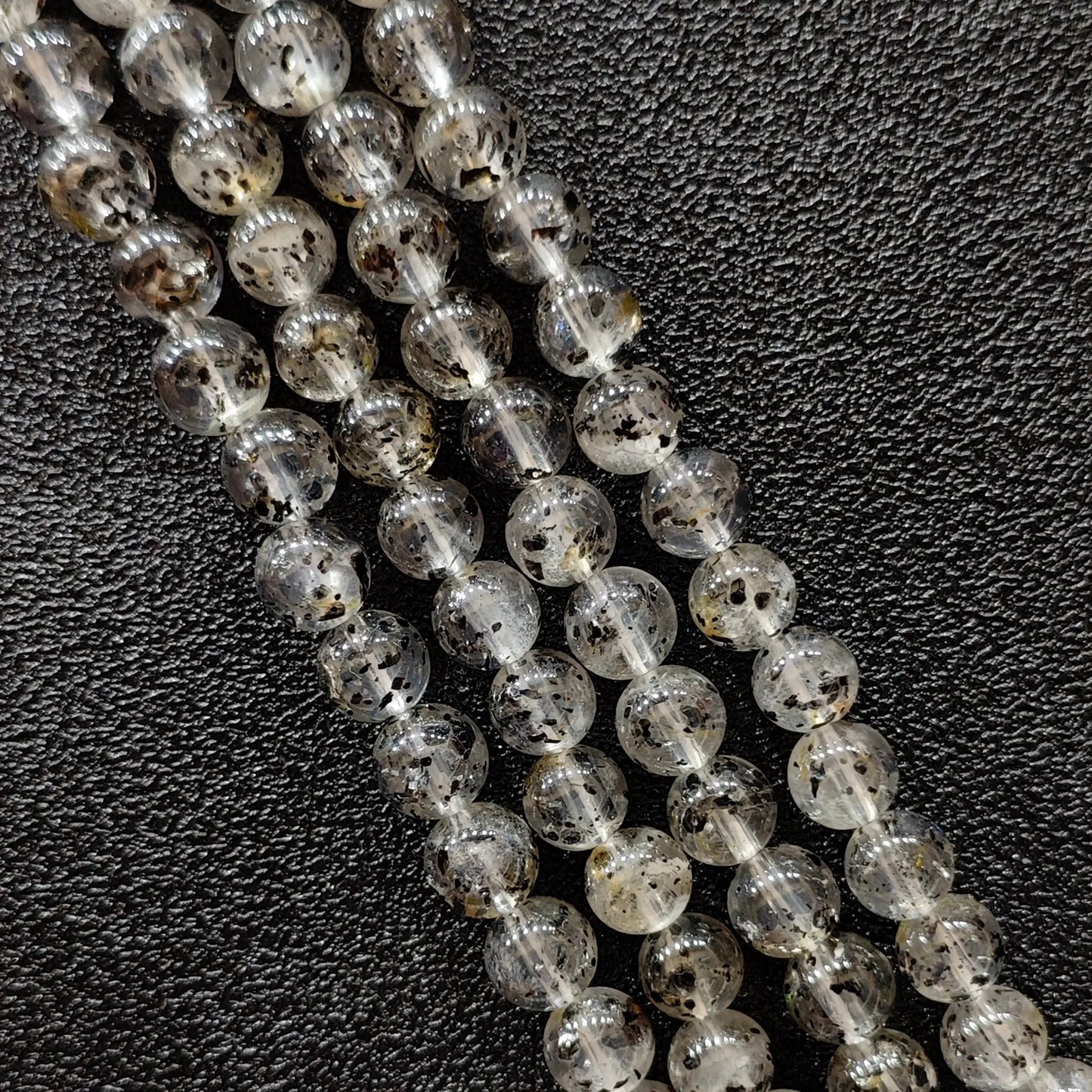 Biotite quartz crystal beads strands showing rich black mica mineral inclusions in clear gemstone round shapes