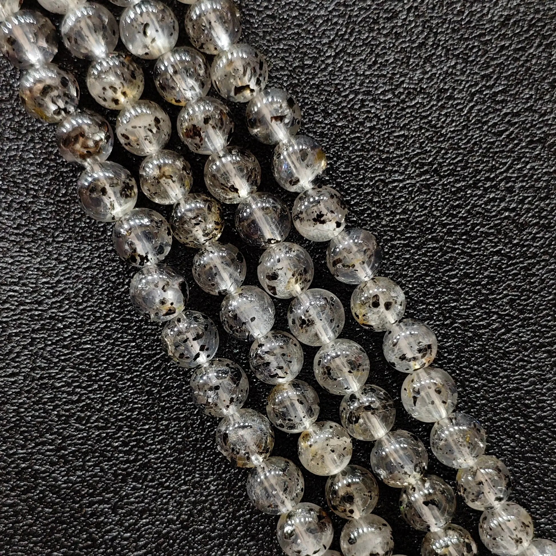 Biotite quartz crystal beads strands showing rich black mica mineral inclusions in clear gemstone round shapes