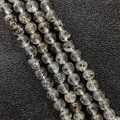 Biotite quartz crystal beads strands showing rich black mica mineral inclusions in clear gemstone round shapes