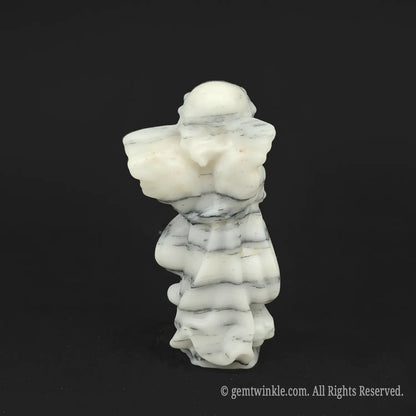 Back view of a hand-carved black and white striped zebra stone angel figurine displaying organic parallel patterns, perfect for unique gifts for him